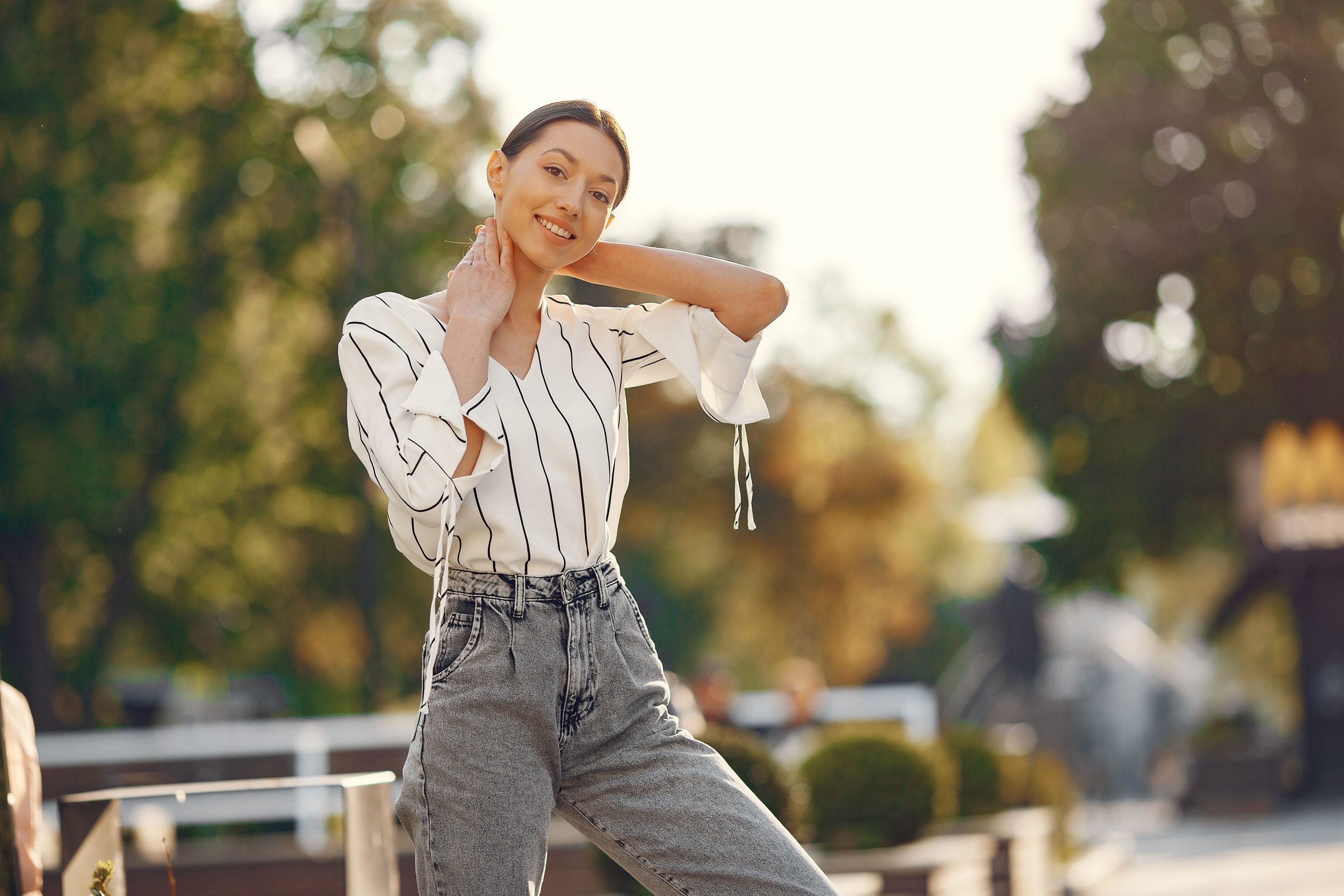 Jeune femme souriante en chemise rayee et jean bootcut